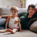 a woman and a child sitting on a couch